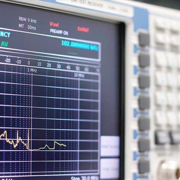 Spectrum analyzer screen displaying electronic interference measurements with list of shielding and filtering solutions